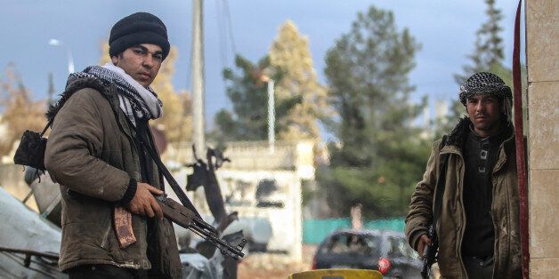KOBANI, SYRIA - JANUARY 30: Members of a Kurdish armed group stands guard in the center of the Syrian town of Kobani (Ayn al-Arab) on January 30, 2015 after it has been freed from Islamic State of Iraq and the Levant (ISIL) forces. It is planned that a part of Kobani will be left as it is for a while to point out terrorism. (Photo by Orhan Cicek/Anadolu Agency/Getty Images)