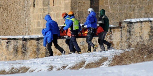 French rescuers carry on January 25, 2015 in church of Ceillac the body of one of six skiers victims of an avalanche a day earlier in the French Alps. Rescue workers found today the bodies of the six skiers who went missing after being carried away by an avalanche during a trek in the Queyras mountain range. AFP PHOTO/ JEAN-PERRE CLATOT (Photo credit should read JEAN-PIERRE CLATOT/AFP/Getty Images)