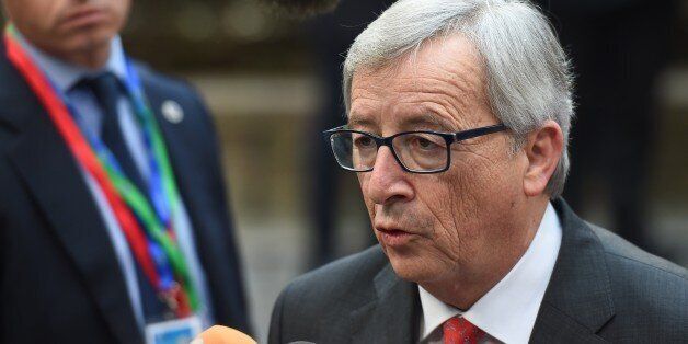 European Commission President Jean-Claude Juncker speaks with journalists as he arrives ahead of the European Council Summit at the European Union (EU) Headquarters in Brussels on February 12, 2015. AFP PHOTO / EMMANUEL DUNAND (Photo credit should read EMMANUEL DUNAND/AFP/Getty Images)
