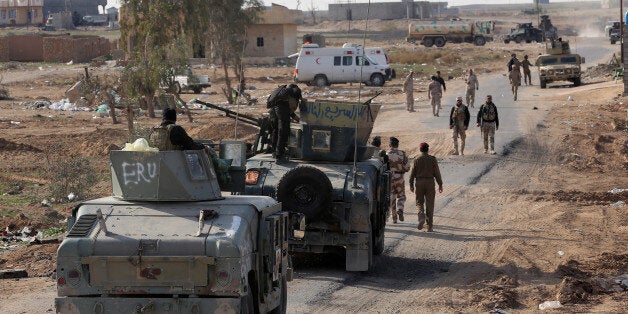 Iraqi security forces are deployed during a military operation to regain control of the villages around the town of Beiji, some 250 kilometers (155 miles) north of Baghdad, Iraq, Monday, Dec. 8, 2014. The commander of U.S. forces fighting the Islamic State in Iraq and Syria, Army Lt. Gen. James Terry says the extremist group has been thrown on the defensive, because coalition airstrikes and other measures are taking a toll on IS ability to communicate. (AP Photo/Hadi Mizban)