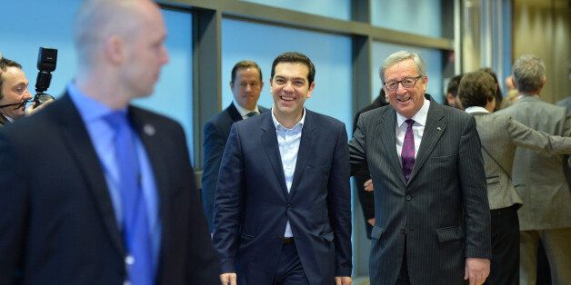 BRUSSELS, BELGIUM - FEBRUARY 04: Greek Prime Minister Alexis Tsipras (C) walks next to European Commission President Jean-Claude Juncker (R) at the European Commission headquarters in Brussels on February 4, 2015. (Photo by Dursun Aydemir/Anadolu Agency/Getty Images)