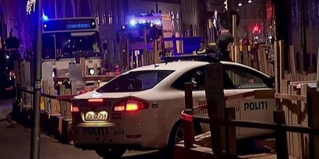 This image made from TV2 via Associated Press News video shows the scene near a synagogue where police reported a shooting in downtown Copenhagen, Denmark, Sunday, Feb. 15, 2015. One person was shot in the head and two police officers were shot in the arms and legs, police said. (AP Photo/TV2 via APTN) DENMARK OUT
