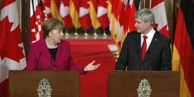 Chancellor Angela Merkel (L) and Canadian Prime Minister Stephen Harper (R) speak at a joint press conference on Parliament Hill in Ottawa, February 9, 2015. AFP PHOTO / Patrick DOYLE (Photo credit should read PATRICK DOYLE/AFP/Getty Images)
