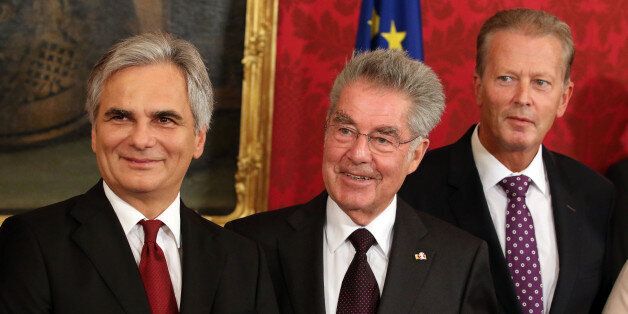 Austrian Chancellor Werner Faymann, Austrian President Heinz Fischer and new Vice Chancellor Reinhold Mitterlehner, from left, pose for press during the inauguration ceremony of the new grand coalition government at the Hofburg palace in in Vienna, Austria, Monday, Sept. 1, 2014. (AP Photo/Ronald Zak)
