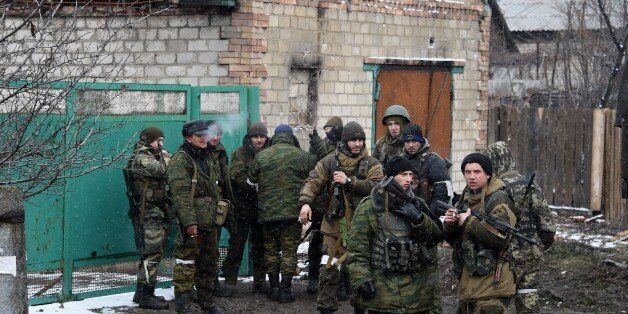 Pro-Russian separatist fighters prepare on February 9, 2015 to go to the frontline near Uglegorsk, 6 kms southwest of Debaltseve. The European Union on February 9 put fresh sanctions against Moscow on hold ahead of a summit to thrash out a Ukraine peace plan aimed at ending 10 months of bloodshed. And US President Barack Obama said on February 9 that the United States had no desire to 'weaken' Russia, but the West had to impose a cost for Moscow's aggression in Ukraine. AFP PHOTO /