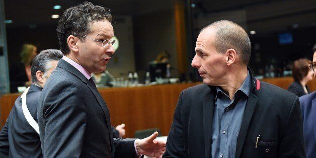 Eurogroup President and Dutch Finance Minister Jeroen Dijsselbloem (L) speaks with Greece's Finance Minister Yanis Varoufakis as they arrive to take part in an European economic and financial affairs (ECOFIN) meeting at the European Council in Brussels, on February 17, 2015. AFP PHOTO/Emmanuel Dunand (Photo credit should read EMMANUEL DUNAND/AFP/Getty Images)