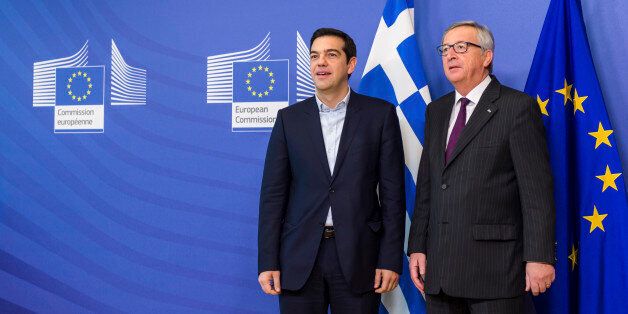European Commission President Jean-Claude Juncker, right, stands with Greece's Prime Minister Alexis Tsipras upon his arrival at the European Commission headquarters in Brussels Wednesday, Feb. 4, 2015. Tsiparis is on a one day trip to Brussels to meet with EU leaders. (AP Photo/Geert Vanden Wijngaert)