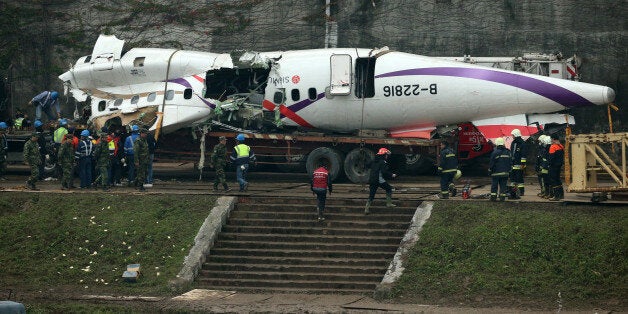 TAIPEI, TAIWAN - FEBRUARY 05: (CHINA OUT) Emergency workers clear the debris a day after the TransAsia Airways ATR 72-600 turboprop airplane crash on February 5, 2015 in Taipei, Taiwan of China. The plance, caught in dramatic video, crashed into the Keelung River shortly after taking off from Taipei Songshan airport February 4. Thirty-two people are confirmed dead, with 11 still missing. Fifteen people were pulled from the river alive. (Photo by ChinaFotoPress/ChinaFotoPress via Getty Images)