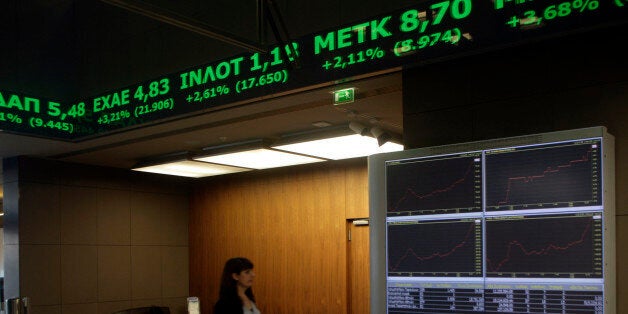 ATHENS, GREECE - JANUARY 12: A woman walks inside the Stock Exchange on January 12, 2015 in Athens, Greece. Global markets have been shaken by fears that Greece could abandon the Euro if the radical left-wing Syriza party wins the election. (Photo by MIlos Bicanski/Getty Images)