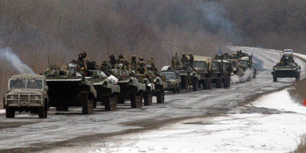 A column of Ukrainian forces roles to Debaltseve as it moves near the eastern Ukrainian town of Artemivsk, in the Donetsk region on February 10, 2015. At least six civilians were killed and 21 wounded in a rocket attack on Ukraine's military headquarters in the war-torn east, local authorities said. The attack also hit residential areas of Kramatorsk, which is considered to be under firm Kiev control. AFP PHOTO / VOLODYMYR SHUVAYEV (Photo credit should read VOLODYMYR SHUVAYEV/AFP/Getty Im