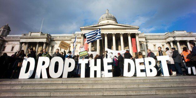LONDON, UNITED KINGDOM - 2015/02/15: Protesters hold placards demanding the the European Union to drop the debt of Greece. Hundreds of protester rally at Trafalgar Square in the English Captial to support of the newly elected government officials in Greece to negotiate a better deal with the European Union with regard to the Greek national debt crisis. (Photo by Geovien So/Pacific Press/LightRocket via Getty Images)