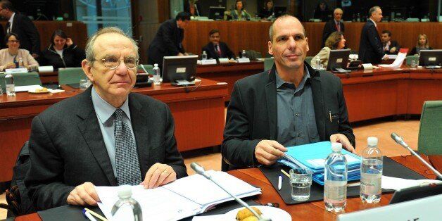 BRUSSELS, BELGIUM - FEBRUARY 17: Greek Finance Minister Yanis Varoufakis (R) and Italy's Economy Minister Pier Carlo Padoan (L) attend to European Economic and Financial Affairs (ECOFIN) meeting at the European Council in Brussels, on February 17, 2015. (Photo by Dursun Aydemir/Anadolu Agency/Getty Images)
