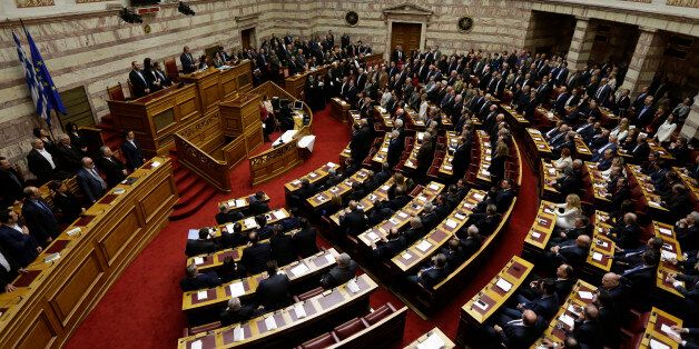 Lawmakers elected in Greece's Jan. 25 national elections are sworn in taking a secular oath at the first convention of Parliament since the elections in Athens on Thursday, Feb. 5, 2015. Non Greek Orthodox lawmakers were sworn in with a secular, or Muslim version of the oath. Jittery investors dumped Greek shares Thursday after the European Central Bank tightened the screws on the country's banking system, piling pressure on the new anti-austerity government to seek a compromise with bailout creditors. (AP Photo/Thanassis Stavrakis)
