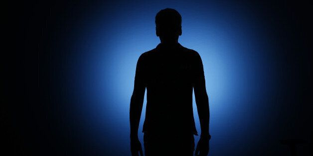BERLIN, GERMANY - AUGUST 06: Silhouette of a man standing in front of a blue background on August 06, 2014, in Berlin, Germany. (Photo by Thomas Trutschel/Photothek via Getty Images)***Local Caption***