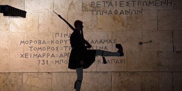 ATHENS, GREECE - JANUARY 21: Greek Presidential Guard soldiers perform their duties in front of the the Greek Tomb of the Unknown Soldier beneath the Hellenic Parliament which is home to the Greek parliament ahead of this weekend general election on January 21, 2015 in Athens, Greece. According to the latest opinion polls, the left-wing Syriza party are poised to defeat Prime Minister Antonis Samaras' conservative New Democracy party in the election, which will take place on Sunday. European le