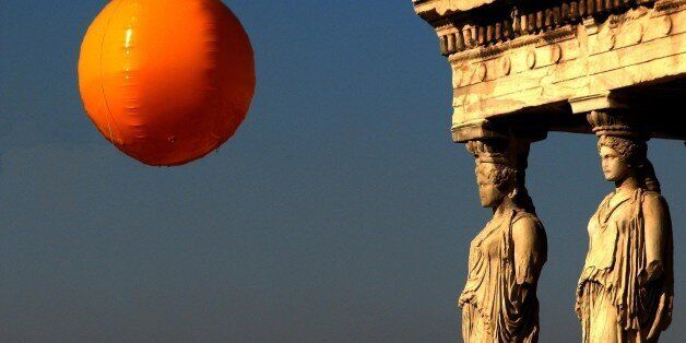 A photographer's balloon above the Acropolis of Athens, Greece, as supervised by the Caryatids standing nearby.