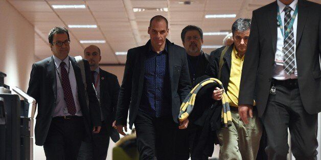 Greek Finance Minister Yanis Varoufakis (C) heads to a press conference on February 16, 2015 at the end of an Eurogroup finance ministers meeting at the European Council in Brussels. Eurozone ministers handed Greece an ultimatum to request an extension to its hated bailout program on February 16 after crunch talks collapsed, deepening a bitter stand-off that risks seeing Athens tumble out of the eurozone. Eurogroup head Jeroen Dijsselbloem said Greece had the rest of the week to request an extension to the programme, which expires at the end of the month, challenging Athens to cave on a dearly held position. AFP PHOTO / EMMANUEL DUNAND (Photo credit should read EMMANUEL DUNAND/AFP/Getty Images)