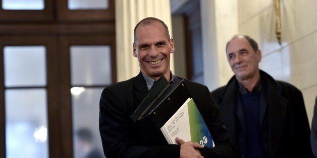 Greek Finance Minister Yanis Varoufakis listens on February 11, 2015 to the press conference of the Greek...