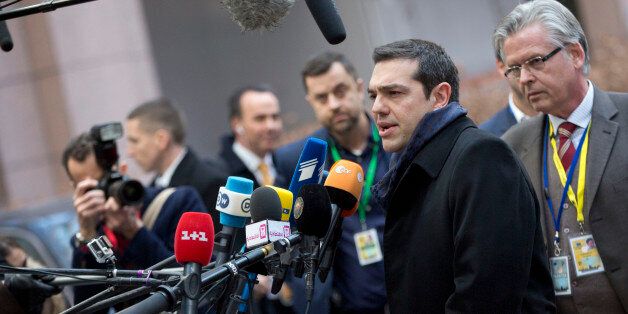 Greek Prime Minister Alexis Tsipras, second right, speaks with the media as he arrives for an EU summit in Brussels on Thursday, Feb. 12, 2015. EU leaders meet for a one-day summit on Thursday to discuss, among other issues, European banks and the situation in Ukraine.(AP Photo/Virginia Mayo)