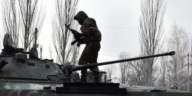 A Pro-Russian separatist stands on the top af a tank on February 9, 2015 in Uglegorsk, 6 kms southwest of Debaltseve. The European Union on February 9 put fresh sanctions against Moscow on hold ahead of a summit to thrash out a Ukraine peace plan aimed at ending 10 months of bloodshed. And US President Barack Obama said on February 9 that the United States had no desire to 'weaken' Russia, but the West had to impose a cost for Moscow's aggression in Ukraine. AFP PHOTO / DOMINIQUE FAGET (Photo credit should read DOMINIQUE FAGET/AFP/Getty Images)