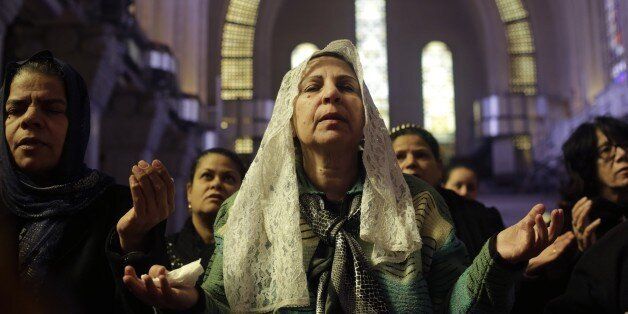 Women pray during a mass lead by Pope Tawadros II, the 118th pope of the Coptic Church of Egypt, for the Egyptian Christians who were killed in Libya, at St. Mark's Cathedral in Cairo, Egypt, Tuesday, Feb. 17, 2015. An Islamic State video released on 15 February claimed to show the extremist group beheading 21 Egyptian Christians abducted in Libya more than a month ago. The Egyptian army responded on Feb. 16 by an airstrike against the militants targeting bases and weapons storage facilities in