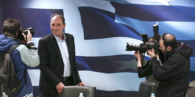 George Stathakis, Greece's incoming minister for economy, shipping, tourism and infrastructure, is photographed as he arrives for a handover ceremony in Athens, Greece, on Wednesday, Jan. 28, 2015. Yanis Varoufakis, Greece's finance minister, is gearing up for negotiations with the euro area that have been on hold since December as Greece entered an election campaign. Photographer: Yorgos Karahalis/Bloomberg via Getty Images *** George Stathakis