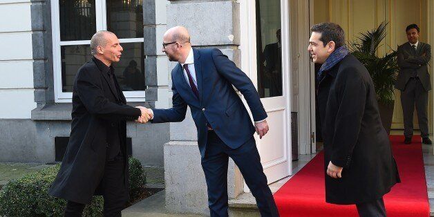 Belgian Prime Minister Charles Michel (C) welcomes Greek Finance Minister Yanis Varoufakis (L) and Greek Prime Minister Alexis Tsipras prior to their meeting within a European summit in Brussels on February 12, 2015. AFP PHOTO / EMMANUEL DUNAND (Photo credit should read EMMANUEL DUNAND/AFP/Getty Images)