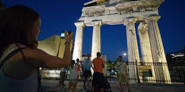 ATHENS, GREECE - 2014/08/10: Tourists and Greek people photograph themselves in front of Ancient Market...