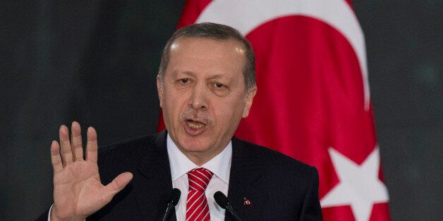 Turkey's President Recep Tayyip Erdogan speaks during a joint press conference with Mexico's President Enrique Pena Nieto after signing bilateral agreements at the National Palace in Mexico City, Thursday, Feb. 12, 2015. (AP Photo/Rebecca Blackwell)