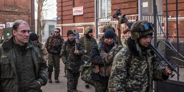 ARTEMIVSK, UKRAINE - FEBRUARY 15: Ukrainian fighters who were able to leave the heavily contested town of Debaltseve arrive from the field on February 15, 2015 in Artemivsk, Ukraine. A ceasefire scheduled to go into effect at midnight was reportedly observed along most of the front, though fighting in Debaltseve continued with Ukrainian forces there effectively surrounded. (Photo by Brendan Hoffman/Getty Images)