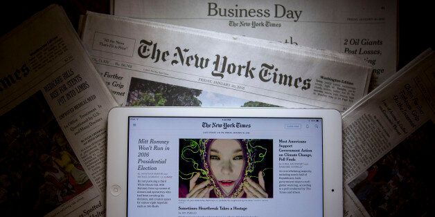 An Apple Inc. iPad displays the New York Times application (app) while sitting on New York Times newspapers in this arranged photograph in Washington, D.C., U.S., on Friday, Jan. 30, 2015. The New York Times Co. is expected to release fourth-quarter earnings on Feb. 3. Photographer: Andrew Harrer/Bloomberg via Getty Images