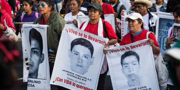 MEXICO CITY, MEXICO - JANUARY 26: Relatives of the missing students, attend a protest for the 43 missing students, in Mexico City, Mexico on January 26, 2015 after four months of their disappearance in Iguala, Guerrero. (Photo by Daniel Cardenas/Anadolu Agency/Getty Images)