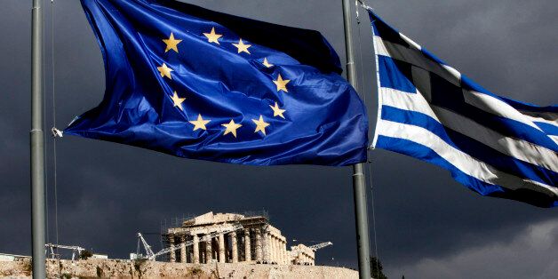A European Union (EU) flag, left, and Greek national flag fly near the Parthenon temple on Acropolis hill in Athens, Greece, on Monday, Oct. 31, 2011. Europe's plan to solve the region's debt crisis made credit-default swaps covering Greece 'ineffective,' Moody's Investors Service said. Photographer: Angelos Tzortzinis/Bloomberg via Getty Images