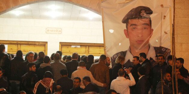 AMMAN, JORDAN - FEBRUARY 03:Angry Jordanians gather after after hearing the news of the execution of Jordanian pilot Muath Al Kasasbeh, at the Kasasbeh tribe society on February 3, 2015 in Amman, Jordan. Today a video was released depicting captured Jordanian pilot First Lieutenant Moaz al-Kasabeh being burned alive in a cage by the Islamic State (ISIS) group. (Photo by Jordan Pix/Getty Images)