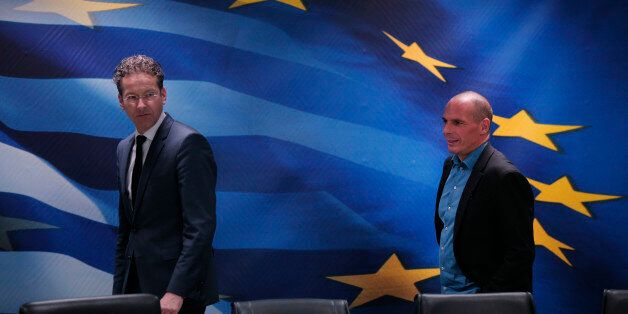 Dutch Finance Minister and Eurogroup President Jeroen Dijsselbloem, left, followed by Greece's Finance Minister Yanis Varoufakis, right, arrive for a joint news conference following their meeting at the Finance Ministry in Athens, Friday, Jan. 30, 2015. Dijsselbloem who chairs eurozone finance meetings says there is no decision so far on what to do after Greeceâs current bailout program runs out at the end of next month. (AP Photo/Lefteris Pitarakis)