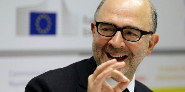 EU Commissioner for Economic and Financial Affairs Pierre Moscovici speaks during a news conference in Athens on Tuesday, Dec. 16, 2014. A refusal by Greece to repay bailout debts would be