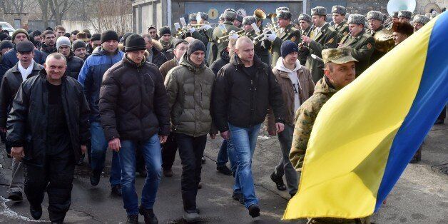 Column of reservists, called up to participate in the fighting in the east of Ukraine, march during a ceremony held at a one of the recruiting offices in Kiev on January 29, 2015. Ukrainian President Petro Poroshenko on January 29 called for urgent truce talks with pro-Russian rebels to end a bloody surge in fighting. Poroshenko said the new meeting in the Belarussian capital should lead to 'an immediate ceasefire and the withdrawal of heavy weapons from the line of contact.' AFP PHOTO/ SERGEI S