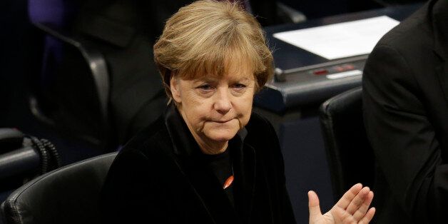 German Chancellor Angela Merkel applauds during a ceremony commemorating the 70th anniversary of the liberation of the Nazi Auschwitz death camp in the German parliament Bundestag in Berlin, Germany, Tuesday, Jan. 27, 2015. (AP Photo/Michael Sohn)