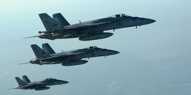 In this Tuesday, Sept. 23, 2014 photo released by the U.S. Air Force, a formation of U.S. Navy F-18E Super Hornets leaves after receiving fuel from a KC-135 Stratotanker over northern Iraq, as part of U.S. led coalition airstrikes on the Islamic State group and other targets in Syria. U.S.-led airstrikes targeted Syrian oil installations held by the militant Islamic State group overnight and early Thursday, Sept. 25, 2014, killing nearly 20 people as the militants released dozens of detainees in