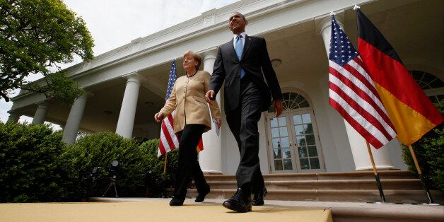 President Barack Obama and German Chancellor Angela Merkel arrive for their joint news conference in the Rose Garden of the White House in Washington, Friday, May 2, 2014. Obama and Merkel are putting on a display of trans-Atlantic unity against an assertive Russia, even as sanctions imposed by Western allies seem to be doing little to change Russian President Vladimir Putin's reasoning on Ukraine. (AP Photo/Charles Dharapak)