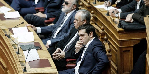 Alexis Tsipras, Greece's prime minister, front center, sits alongside Giannis Dragasakis, Greece's deputy prime minister, ahead of the swearing-in ceremony for the new government held at the Greek Parliament building in Athens, Greece, on Thursday, Feb. 5, 2015. Greece held fast to demands to roll back austerity as the European Central Bank turned up the heat before Finance Minister Yanis Varoufakis was to meet one of his main antagonists, German counterpart Wolfgang Schaeuble. Photographer: Yan