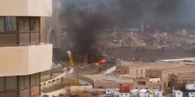 An image grab taken from an AFPTV video shows fire and smoke rising in front of the Corinthia hotel in Tripoli on January 27, 2015 after gunmen stormed the luxury hotel. Gunmen stormed the hotel in Libyan capital popular with diplomats and officials in an attack claimed by the Islamic State group, killing at least nine people including five foreigners before blowing themselves up. AFP PHOTO / AFPTV (Photo credit should read STR/AFP/Getty Images)