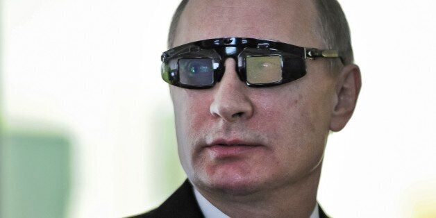 Russian President Vladimir Putin wears special glasses as he visits a research facility of the St. Petersburg State University in St. Petersburg, Russia, on Monday, Jan. 26, 2015. In televised comments after a meeting with students in St. Petersburg, President Vladimir Putin said that Ukraineâs army was at fault for the increase in violence and accused it of using civilians as âcannon fodderâ in the conflict. â(Ukraineâs army) is not even an army, itâs a foreign leg