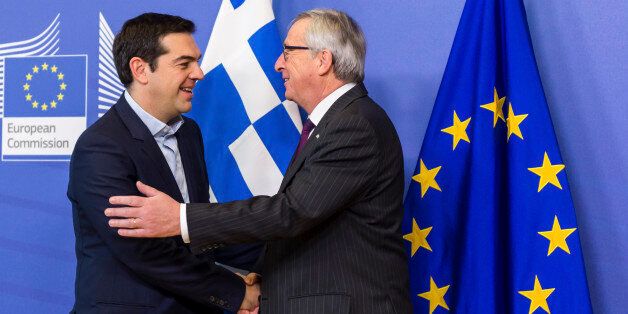 European Commission President Jean-Claude Juncker, right, welcomes Greece's Prime Minister Alexis Tsipras upon his arrival at the European Commission headquarters in Brussels Wednesday, Feb. 4, 2015. Tsiparis is on a one day trip to Brussels to meet with EU leaders. (AP Photo/Geert Vanden Wijngaert)