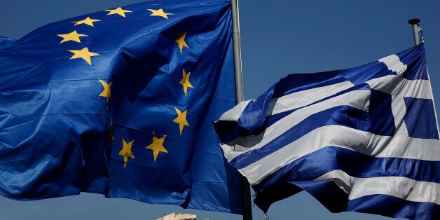 An EU and a Greek flag fly in front of the ancient Parthenon temple, in Athens, on Wednesday, April 9, 2014. Greece announced Wednesday it was returning to international bond markets for the first time in four years amid growing signs of confidence in the country at the forefront of the European debt crisis. (AP Photo/Petros Giannakouris)