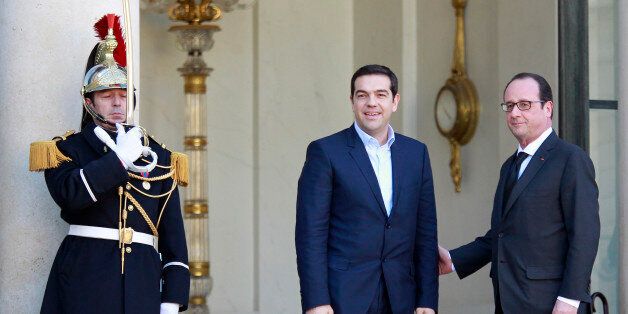 French President Francois Hollande, right, poses with Greek prime minister Alexis Tsipras prior to their meeting at the Elysee Palace in Paris, Wednesday Feb. 4, 2015. Riding a wave of popular discontent with an EU austerity drive led by economic powerhouse Germany, Tsipras has so far shunned the so-called troika â the European Commission, European Central Bank and the International Monetary Fund. (AP Photo/Remy de la Mauviniere)