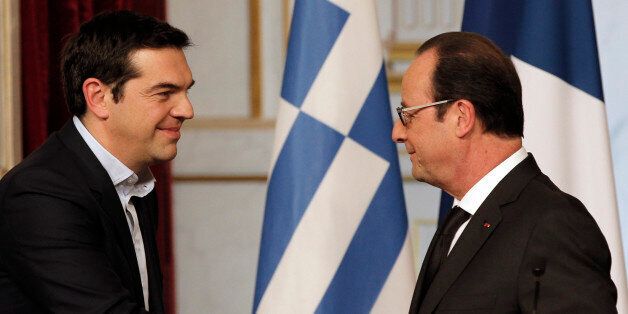 Greece's Prime Minister Alexis Tsipras, left, and French President Francois Hollande, shake hands after a press conference at the Elysee Palace, in Paris, France, Wednesday, Feb. 4, 2015. In a short trip to Brussels before heading to France, Tsipras was welcomed at the European Commission, one of the three main institutions overseeing Greece's finances, by President Jean-Claude Juncker. (AP Photo/Christophe Ena)