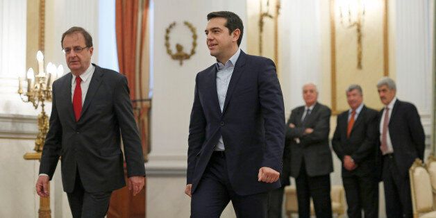 Alexis Tsipras, Greek Prime Minister-elect, center, arrives at the presidential palace to be sworn in as prime minister in Athens, Greece, on Monday, Jan. 26, 2015. The Independent Greeks party will support Syriza in a vote of confidence in Parliament slated for Feb. 5, Independent Greeks Party Leader Panos Kammenos told reporters after meeting with Tsipras. Photographer: Kostas Tsironis/Blooomberg