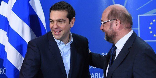 European Parliament President Martin Schulz (R) greets Greek Prime Minister Alexis Tsipras on February 4, 2015 at the European Parliament in Brussels. The euro held its gains on February 4 after a surge driven by growing optimism that Greece will hammer out a debt deal and avoid a possible default. AFP PHOTO / EMMANUEL DUNAND (Photo credit should read EMMANUEL DUNAND/AFP/Getty Images)