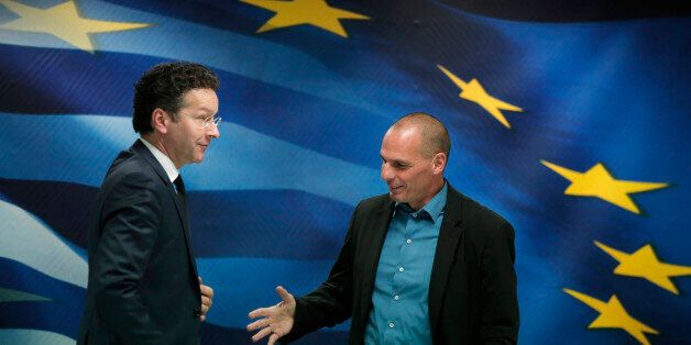 Greece's Finance Minister Yanis Varoufakis, right, reaches out to shake hands with Dutch Finance Minister and Eurogroup President Jeroen Dijsselbloem, left, following a joint news conference after their meeting at the Finance Ministry in Athens, Friday, Jan. 30, 2015. Dijsselbloem who chairs eurozone finance meetings says there is no decision so far on what to do after Greeceâs current bailout program runs out at the end of next month. (AP Photo/Lefteris Pitarakis)